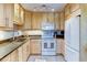 Bright kitchen features modern appliances, granite counters, and light wood cabinets at 9180 E Center Ave # 9D, Denver, CO 80247