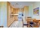 Cozy kitchen includes stainless steel appliances, wood cabinets, and dining space at 9180 E Center Ave # 9D, Denver, CO 80247
