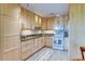 Well-lit kitchen featuring white appliances, and granite counters at 9180 E Center Ave # 9D, Denver, CO 80247