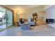 Bright living room featuring a comfortable sofa, stylish furniture, and sliding glass doors to a balcony at 9180 E Center Ave # 9D, Denver, CO 80247