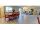 Sunlit living room with modern wood flooring, dining table, and balcony access at 9180 E Center Ave # 9D, Denver, CO 80247