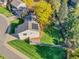 Well-maintained home with solar panels, lush lawn, and mature trees providing shade and beauty at 7162 S Fillmore Cir, Centennial, CO 80122