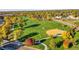 Expansive park with baseball fields, soccer fields, walking paths, and beautiful fall foliage creating a vibrant recreational area at 7162 S Fillmore Cir, Centennial, CO 80122