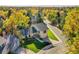 A vibrant aerial view of a home surrounded by mature trees in the fall at 7162 S Fillmore Cir, Centennial, CO 80122