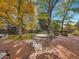 Brick patio with an outdoor dining set surrounded by mature trees at 7162 S Fillmore Cir, Centennial, CO 80122