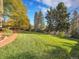 Large backyard featuring lush green grass and mature trees providing ample space for outdoor activities and relaxation at 7162 S Fillmore Cir, Centennial, CO 80122