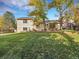 Large backyard with mature trees, lush lawn, and sliding glass doors to patio create an inviting outdoor living space at 7162 S Fillmore Cir, Centennial, CO 80122