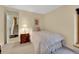 Cozy bedroom featuring carpeted floors and a traditional-style bedside table and stairway at 7162 S Fillmore Cir, Centennial, CO 80122