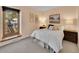 Comfortable bedroom with a window view, bedside tables, and decorative wall art at 7162 S Fillmore Cir, Centennial, CO 80122