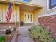 Inviting front porch featuring a charming doorway, decorative plants, and brick accents, creating a welcoming entrance at 7162 S Fillmore Cir, Centennial, CO 80122