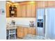Charming kitchen nook with built-in desk, stainless steel refrigerator, and ample cabinet space at 7162 S Fillmore Cir, Centennial, CO 80122