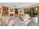 Cozy living room with fireplace, built-in bookshelves, and sliding glass doors to the outdoor space at 7162 S Fillmore Cir, Centennial, CO 80122