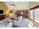 Open living room with high ceilings, custom bookshelves, and expansive windows at 7162 S Fillmore Cir, Centennial, CO 80122