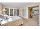 Main bedroom featuring sliding-door closet, carpet flooring and view to living area at 7162 S Fillmore Cir, Centennial, CO 80122