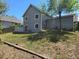 Lawn backyard with grass and wooden border and showing gray home's siding at 17605 E Temple Dr, Aurora, CO 80015