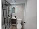 Modern bathroom featuring walk-in shower with black frame and vanity with illuminated mirror at 17605 E Temple Dr, Aurora, CO 80015