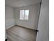 Bedroom featuring a large window and neutral walls and flooring at 17605 E Temple Dr, Aurora, CO 80015