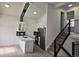 Modern kitchen featuring white cabinets, a stylish black backsplash, and stainless steel appliances at 17605 E Temple Dr, Aurora, CO 80015