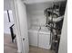 Laundry closet with full-size white washer and dryer, next to furnace at 17605 E Temple Dr, Aurora, CO 80015