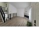 Bright living room with modern fireplace, black metal banister, and lots of light from front door at 17605 E Temple Dr, Aurora, CO 80015