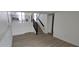 Modern living room with stairs and sleek black railing at 17605 E Temple Dr, Aurora, CO 80015