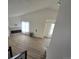 Open-concept living space with a vaulted ceiling and modern fireplace at 17605 E Temple Dr, Aurora, CO 80015