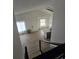 Open-concept floor plan showcasing the kitchen, dining, and living areas, brightened by natural light at 17605 E Temple Dr, Aurora, CO 80015
