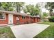 The backyard has a concrete patio extending from a well-kept brick home with a manicured lawn at 6340 Quay St, Arvada, CO 80003