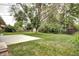 Expansive backyard with lush green grass, mature trees, and a concrete patio at 6340 Quay St, Arvada, CO 80003