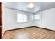 Bright, airy bedroom featuring hardwood floors and windows with white blinds at 6340 Quay St, Arvada, CO 80003