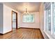 Elegant dining area with hardwood floors, large window, and modern lighting at 6340 Quay St, Arvada, CO 80003