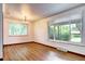 Bright room features wood floors, modern lighting, large windows, and neutral walls at 6340 Quay St, Arvada, CO 80003
