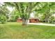 Charming home featuring a well-maintained front yard with mature trees and a long driveway at 6340 Quay St, Arvada, CO 80003