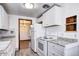 Kitchen with white cabinets, stone countertops, and modern appliances at 6340 Quay St, Arvada, CO 80003