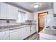 Kitchen with white cabinets, stone countertops, and modern appliances at 6340 Quay St, Arvada, CO 80003