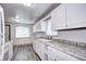 Bright kitchen featuring white cabinets, granite countertops, and stainless-steel appliances at 6340 Quay St, Arvada, CO 80003