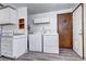 Laundry area featuring new appliances, cabinets, and adjacent doorway at 6340 Quay St, Arvada, CO 80003