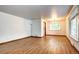 Bright and airy room features hardwood floors, large windows, modern lighting, and neutral walls at 6340 Quay St, Arvada, CO 80003