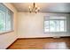 Bright and airy room features hardwood floors, large windows, modern lighting, and neutral walls at 6340 Quay St, Arvada, CO 80003