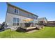 Well-maintained backyard featuring a deck with an umbrella and artificial grass at 14419 Dahlia St, Thornton, CO 80602