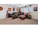 Finished basement complete with leather sofa, sports decor, windows and orange and blue themed accessories at 14419 Dahlia St, Thornton, CO 80602