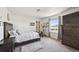 Bedroom displaying a bed, dresser, an exercise bike and a decorative sliding barn door with modern farmhouse style at 14419 Dahlia St, Thornton, CO 80602