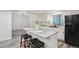 Eat-in kitchen with granite counters, modern appliances, island, and barstool seating at 14419 Dahlia St, Thornton, CO 80602
