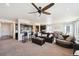 Open-concept living room with a ceiling fan, sofa, and adjacent kitchen and dining area for easy entertaining at 14419 Dahlia St, Thornton, CO 80602