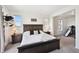 Main bedroom showcasing a wooden bed frame, two windows for ample light and bedside tables with lamps at 14419 Dahlia St, Thornton, CO 80602