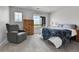 Bedroom featuring plush carpet, large windows, gray chair, and a wood dresser at 6350 N Lisbon St, Aurora, CO 80019