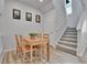 Cozy dining area with wood table, seating for four, and staircase at 6350 N Lisbon St, Aurora, CO 80019