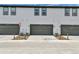 Exterior view of townhome garages with modern doors and driveways at 6350 N Lisbon St, Aurora, CO 80019