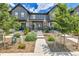 Modern townhomes feature a stylish exterior with stone accents and well-maintained landscaping at 6350 N Lisbon St, Aurora, CO 80019