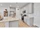 Bright kitchen features stainless steel appliances, granite counters, light gray cabinets, and hardwood floors at 6350 N Lisbon St, Aurora, CO 80019